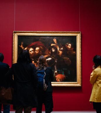 Visitors to Beyond Caravaggio in front of the Taking of Christ. © National Gallery of Ireland.