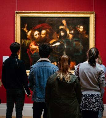 Visitors in front of the Taking of Christ in the exhibition Beyond Caravaggio. © National Gallery of Ireland.