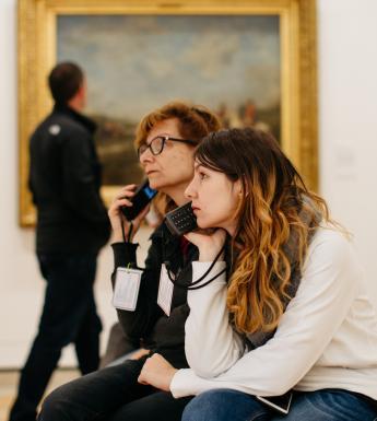 Visitors to the gallery listening to audioguides. © National Gallery of Ireland.