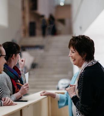 Visitors at the information desk in the Millennium Wing. © National Gallery of Ireland.