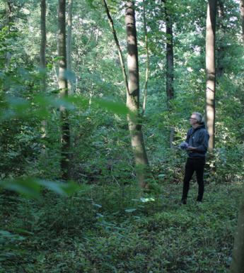 Artist Garrett Phelan recording sound in the field where the Battle of the Somme took place.