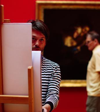 A visitor working at an easel in the Gallery.