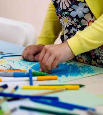 A child drawing during a drop-in family workshop at the Gallery.