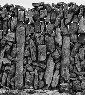 Black and white close-up photograph of a dry-stone wall.