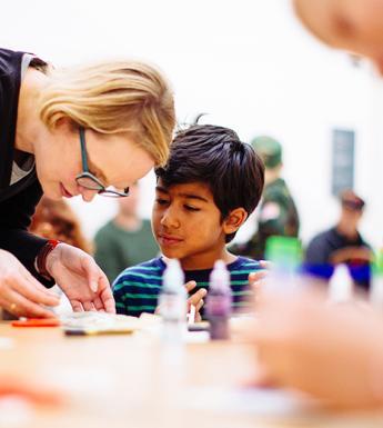 Photo of a young boy making art with a woman during a creative workshop at the National Gallery of Ireland.