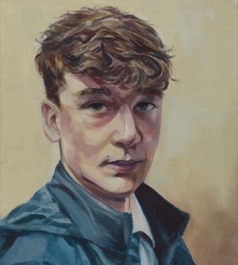 A young man wearing a blue anorak over a white school shirt and tie looks directly at the the viewer.