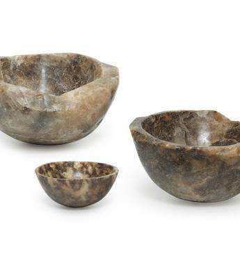 Three brown-hued bowls carved out of rock salt