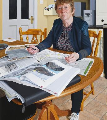 Realistic portrait of a woman with short brown hair seated at the kitchen table with papers spread in front of her