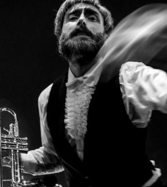 Photograph of a trumpet player in motion.