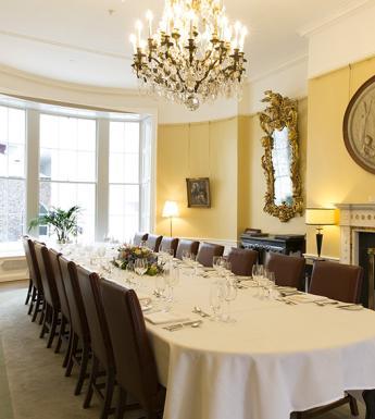 A room with dining table set up for event