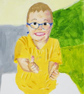 A portrait of a young boy in a yellow t-shirt and blue glasses. He is smiling and has both hands outstretched with his thumbs up.s