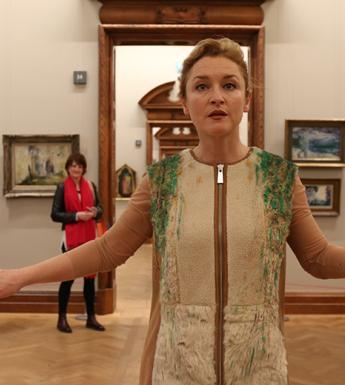 Performance artist Amanda Coogan walking through the National Gallery of Ireland as part of her performance Floats in the Aether.