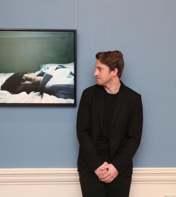 Hennessy Portrait Prize 2017 winner Jack Hickey, pictured in front of his winning painting, 'My Time'. Photograph by Leon Farrell.