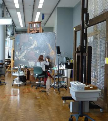 A view of the conservation studio in the Getty Museum with maria Canavan working on Guercino's painting called Jacob Blessing the Sons of Joseph.