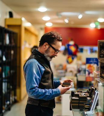 Photo of a man standing in the National Gallery of Ireland shop.