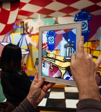 Hands holding up a tablet to take a photograph of Maser's installation for the After Vermeer display at the National Gallery of Ireland in September 2017.