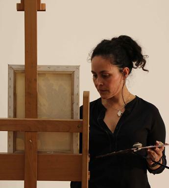 A woman painting at an easel