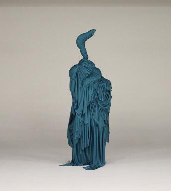 Teal-coloured sculptural costume made from draped cloth and resembling a bird with a long neck