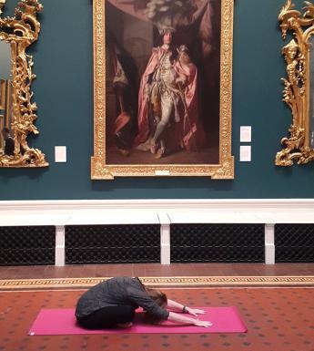A yoga class taking place in the Grand Gallery of the National Gallery of Ireland.