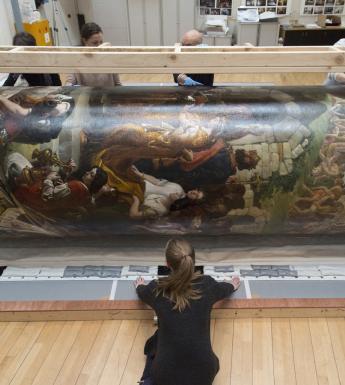 Members of the National Gallery of Ireland's conservation team rolling 'The Marriage of Strongbow and Aoife' in preparation for its move. 