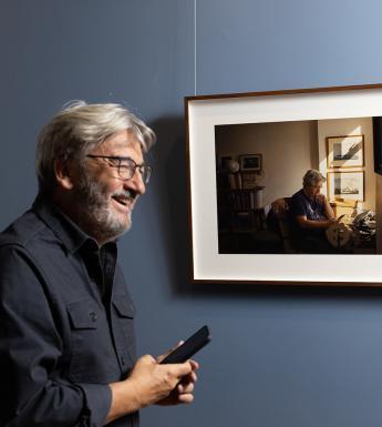 Fergal Keane smiling in front of his portrait by artist Enda Bowe in the National Gallery of Ireland