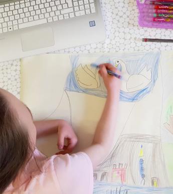 A view from above of a child drawing a picture