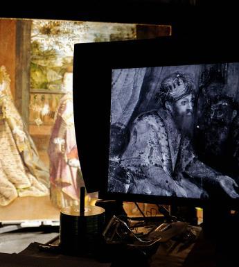 A monitor in a studio showing an infrared image of Lavinia Fontana's painting with the painting partially visible in the background.