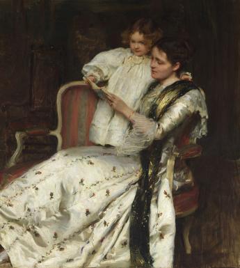 A woman in a long full-skirted white dress with small rosettes on it reclines on a chair. Standing beside her with her hand around her neck is a small child, also in white. They are both reading a book together.