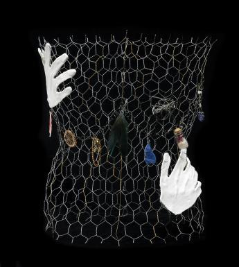 Chicken wire with white clay hands and found objects attached