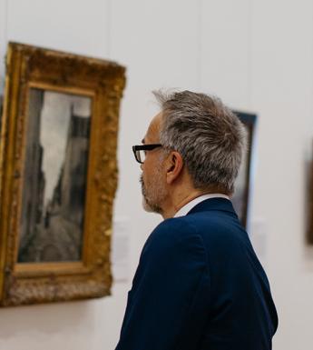 Man looking at a painting in the Millennium Wing of the National Gallery of Ireland.