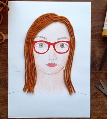 Portrait of a young woman with red glasses and red wool hair