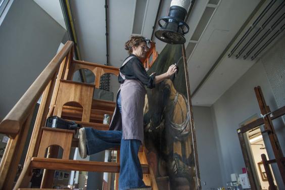 Getty Paintings conservator Devi Ormond cleans Guercino's 'Jacob Blessing the Sons of Joseph', c. 1620. Photo © Getty Museum