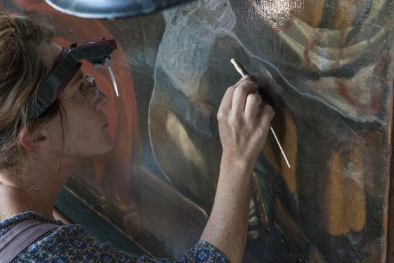 Getty Paintings conservator Devi Ormond cleans Guercino's 'Jacob Blessing the Sons of Joseph', c. 1620. Photo © Getty Museum