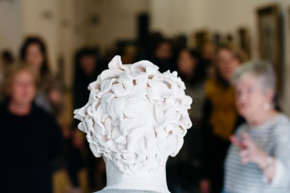 A tour group from behind the bust of Gerry Hynes by Vera Klute. © National Gallery of Ireland. 