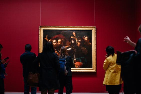 Visitors to Beyond Caravaggio in front of the Taking of Christ. © National Gallery of Ireland.