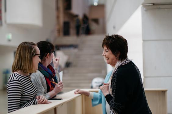 Visitors at the information desk in the Millennium Wing. © National Gallery of Ireland.