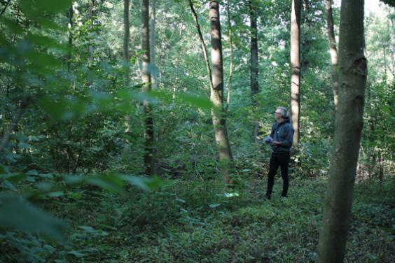 Artist Garrett Phelan recording sound in the field where the Battle of the Somme took place.