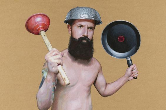A man with a thick black beard holds aloft a toilet plunger and a frying pan. On his head he wears a colander. He is unclothed, and has a large tatoo on his right arm.