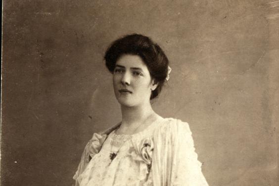 A sepia photograph of Ruth Pollexfen wearing a lace dress