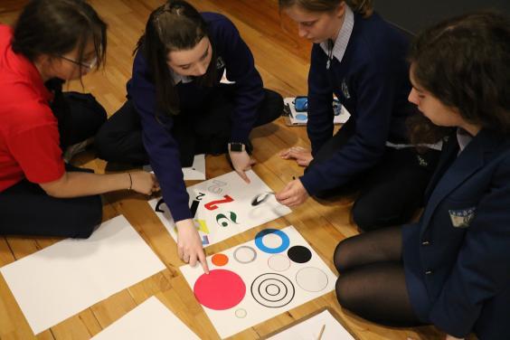 Group of teenagers working on a project in a Gallery workshop