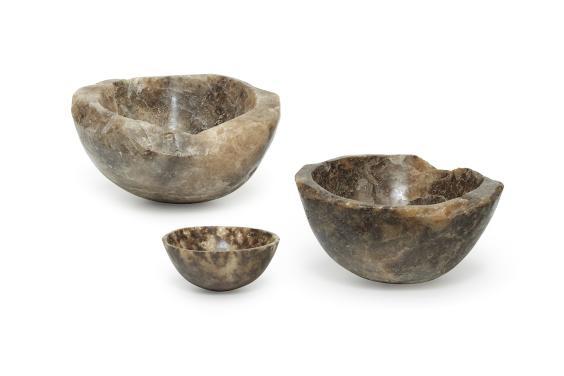 Three brown-hued bowls carved out of rock salt