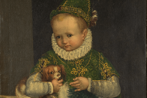 Portrait of a small child in a green dress with white ruff and a green pointed hat, holding a small dog.
