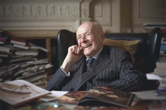 Photographic portrait of Denis Mahon seated at a desk