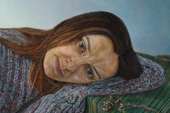 A painting of a young woman wearing a grey jumper, leaning her head on her arm