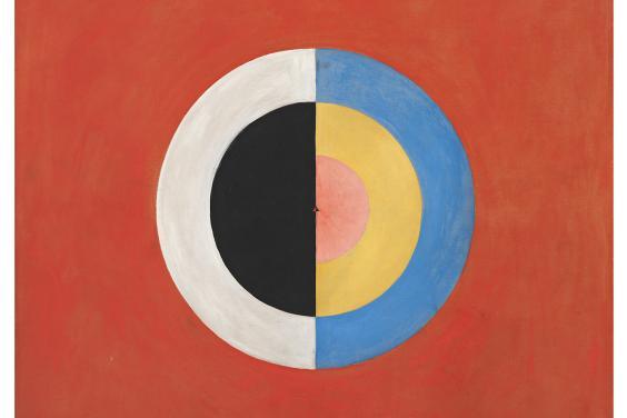 Abstract painting of a concentric circle, painted in semi-circles of white, black, blue, yellow and red, on a solid red background.