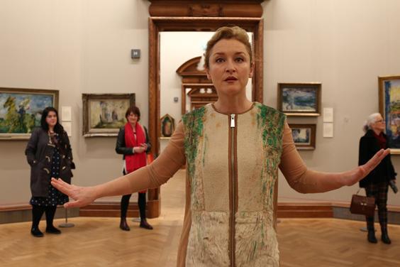 Performance artist Amanda Coogan walking through the National Gallery of Ireland as part of her performance Floats in the Aether.