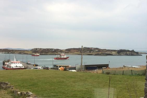 Photo of boats coming into harbour on Inishbofin