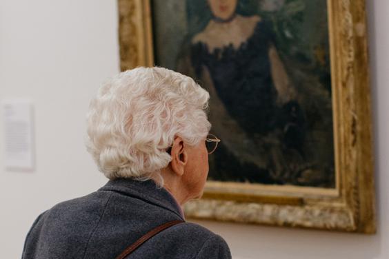 A visitor looking at Berthe Morisot's painting Corsage Noir in the Millennium Wing of the National Gallery of Ireland.