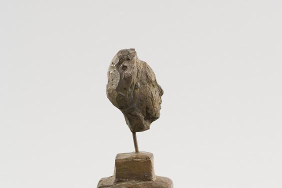 Tiny portrait bust of Simone de Beauvoir mounted on a tiny plinth