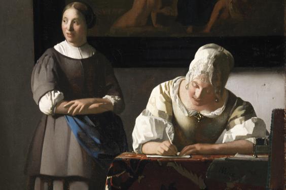 Painting of a woman standing and looking out a window behind a woman with a white bonnet sitting at a desk writing a letter.